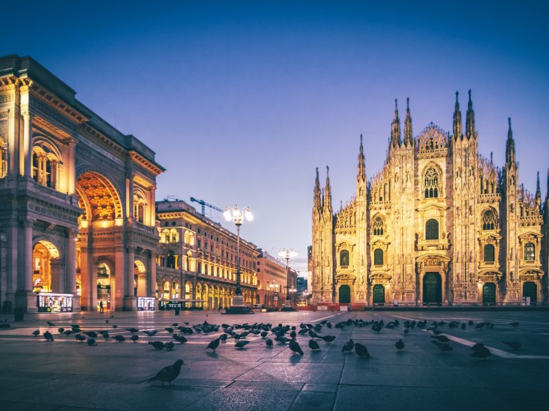 Stunning view of the Duomo Cathedral in Milan, showcasing its intricate Gothic architecture and majestic spires under a clear sky